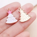 Pink and white Christmas tree alloy pendants for DIY bracelets shown in palm for scale - Pink Christmas Star Xmas Tree Style (24981)