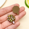 Macro detail of resin lollipop pendant with colorful spiral patterns for DIY crafts - Coffee Brown Resin Lollipop (24576) / 26x17x5mm