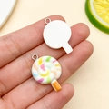 Detailed close-up of resin lollipop charms with colorful spiral patterns for DIY crafts - White Resin Lollipop (24574) / 26x17x5mm