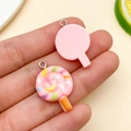 Macro detail of a 3D resin lollipop charm with pink swirl design for DIY jewelry - Pink Resin Lollipop (24571) / 26x17x5mm