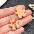 Handheld ginger cookie man charm pendant in yellow resin with red bowtie and blue buttons - Brown Resin Christmas Ginger Man Style(19711)