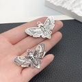 Close-up of vintage silver alloy butterfly and skull moth pendants for DIY jewelry - Death Skull Moth Butterfly Style (16928)