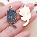 Pair of black enamel cat charms in climbing pose with gold metal backing for DIY jewelry - 1 Piece (11x28.5mm)