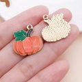 Detailed close-up of orange enamel pumpkin charms with golden metal texture for DIY crafts - Orange Drip Oil Pumpkin Leaf Charm (25061) / 21x20x2mm