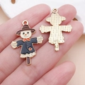 Macro view showing front and back of scarecrow alloy enamel pendants for DIY jewelry - Black Drip Oil Thanksgiving Scarecrow Charm (25060) / 31x21x2mm