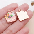 Macro detail of enamel Easter bunny charms on palm showing size and golden textured back - Pink Easter Egg Bunny Envelope (25140)