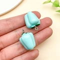 Close-up of light blue resin bell pepper charms with silver rings for DIY crafts - Lake Blue (24128)