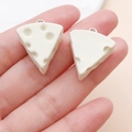 Close-up of miniature resin cheese charm with realistic texture and silver metal ring - Creamy White Triangle Cheese (24650)