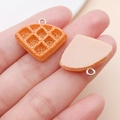 Macro view of 3D resin waffle pendants with realistic texture and silver metal rings - Crepe Bread (24642)