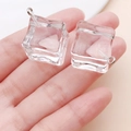 Close-up of a miniature transparent resin ice cube charm with a silver metal hook - Large Transparent White Resin Ice Cube (24109)