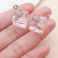 Close-up of a clear resin ice cube charm with a silver metal hook for DIY jewelry - Small Transparent White Resin Ice Cube (24110)