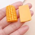 Detailed close-up of 3D resin corn charms for DIY crafts and keychain accessories - Half Corn (24637)