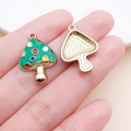 Detail of mushroom charms showing colorful enamel front and textured gold alloy back - 23x16mm Enamel Colored Dots Green Mushroom (18990)