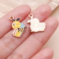 Detail view of double-sided cartoon bee charm showing enamel craft and rose gold back - Yellow Enamel Bee Honey Pot (25156)