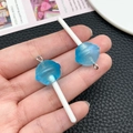 Macro view of blue translucent glitter resin lollipop pendants with silver hooks - Transparent Blue
