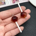 Detailed macro of two glittery brown resin lollipop charms with silver rings for DIY crafts - Transparent Coffee