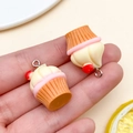 Close-up of resin cupcake charms with striped base and heart cream for DIY jewelry - Cream Apple Cupcake (24087) / 1 Piece (26x18x18mm) / Brown