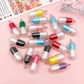 Close-up of colorful resin pill pendants with cute faces and metal loops for DIY jewelry - Random Multicolor Expression Pill Pendants (SN1478)