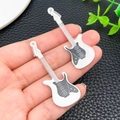 Macro shot of two acrylic electric guitar charms for DIY crafts and jewelry making - White (24058)