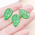 Detailed view of mini green acrylic leaf charms with veins for DIY jewelry making - Dark Green Acrylic Strawberry Leaf (21952)