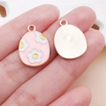 Pink enamel Easter egg charm with white floral pattern and golden metal sunburst back - Pink Easter Flower Egg (25124)