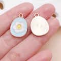 Blue Easter egg pendant with yellow smiley flower and rose gold metal border - Lake Blue Easter Frangipani Egg (25126)