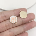 Macro detail of alloy paw print pendant showing golden finish and pink enamel texture - Flesh Pink Enamel Paw (18834)