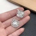 Detailed close-up of retro silver fire department charms with intricate badge engraving - Antique Silver Fire Dept Badge Style (21415)