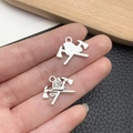 Detail of silver fire department charm with helmet and axes for DIY jewelry making - Antique Silver Fire Tool Axe Style (11312)