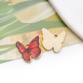 Detail of butterfly charms showing red and black enamel front and textured gold back - 19054 Red Black Spotted Butterfly