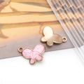 Macro view of gold butterfly pendant connectors with pink marble resin for DIY jewelry - Pink Butterfly Style (11008)