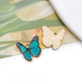 Macro detail of butterfly charm showing blue-green enamel front and textured gold back - 19056 Blue Green Gradient Butterfly