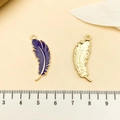 Detailed view of purple feather pendants with gold metallic edges and leaf textures - Purple Feather Pendant (21820)