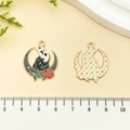 Detailed view of Gothic moon pendants with Scream mask and rose next to a ruler - Scream Mask Moon Crow Style (21745)