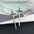 Detail of silver alloy sword pendants with intricate hilt textures and hanging loops - Antique Silver Zinc Alloy Longsword (18720)