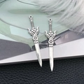 Macro detail of antique silver sword pendants with intricate hilt and top hanging loop - Antique Silver Zinc Alloy Sword (16190)