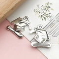 Front and back detail of alloy graduation cap and diploma pendant for DIY crafts - 1 Piece (17x17mm) / Antique Silver