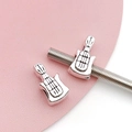 Macro detail of silver guitar-shaped alloy beads with antique finish for DIY jewelry - Antique Silver Guitar Bead (15665)