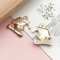 Macro view showing the detailed front and back of a gold graduation cap DIY alloy pendant - 1 Piece (17x17mm) / KC Gold