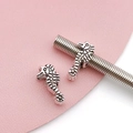 Macro shot of silver seahorse beads on spring wire for DIY bracelet jewelry making - Antique Silver Seahorse Bead (15664)