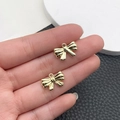 Par de colgantes de lazo dorado pulido para joyería DIY con acabado de espejo liso - Estilo Mini Lazo (21384)