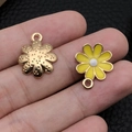 Detailansicht von DIY gelben Gänseblümchen- und Goldblumenanhängern in der Hand - Gelbe Emaille Kleine Gänseblümchen (18787)