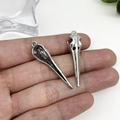 Detail of two bird skull alloy pendants in antique silver finish with hanging loops - Antique Silver Skull Bird Head 10x43 (15551)
