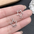 DIY silver star jewelry connectors for necklaces and bracelets on finger for scale - Antique Silver Double-Hanging Pentagram 12x15mm (18730)