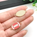 Detailed view of American football charms with enamel stitching and textured metal finish - Red Rugby (21731) / 26x12mm