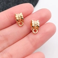 Detalle macro de colgantes de mariposa dorados para bisutería DIY de tamaño mini - Bélière 11x6mm (20659) / Agujero 5mm