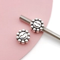 Detailed view of sunflower beads with smiley faces for DIY jewelry making and bracelets - Antique Silver Smiling Sunflower Bead (15675)