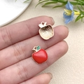 DIY red apple resin charms for jewelry making shown in hand for size reference - Red Drip Oil Zinc Alloy Apple Style (10851)
