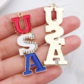 Macro shot of USA letter pendants with red white blue enamel and rhinestones - USA Letter Style