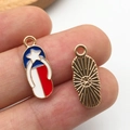 Macro shot of a flip-flop pendant with red white blue enamel stars and golden back - KC Gold Enamel USA Flag Slipper Style (16281)